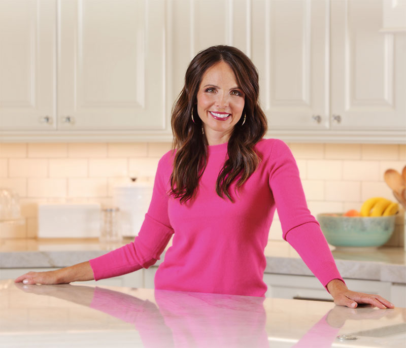 Jenny standing at clean kitchen counter